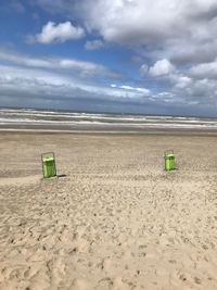 Lifeguard hut on beach against sky