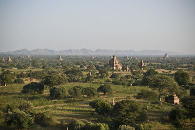 Historic temples amidst trees on landscape against sky