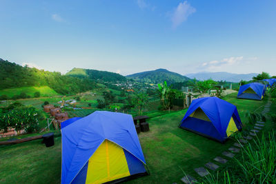 Scenic view of tent on field against sky