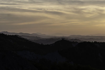 Scenic view of silhouette mountains against sky during sunset