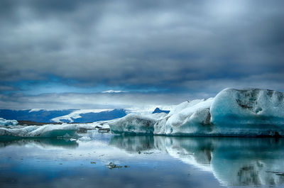 Scenic view of lake with mountains in background