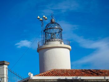 Low angle view of water tower against blue sky