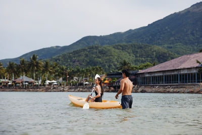 Rear view of man kayaking in sea