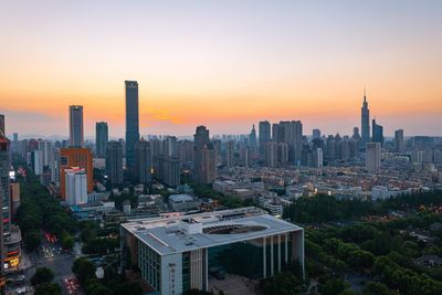 Aerial view of city buildings during sunset