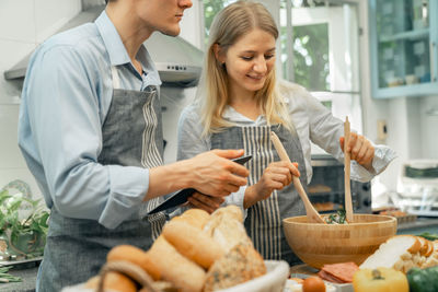 Portrait of young woman preparing food