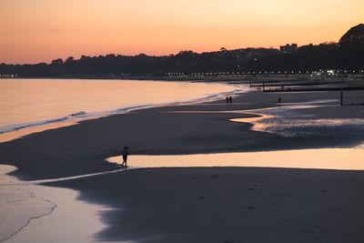 Scenic view of beach against sky during sunset