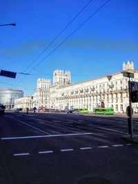 View of city street against blue sky