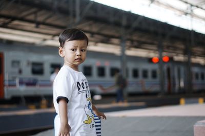 Portrait of boy standing on railroad track