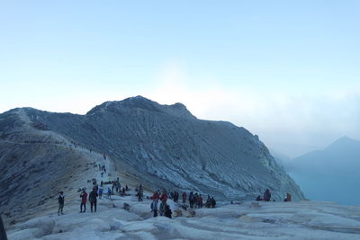 People on snow covered mountain during winter