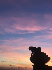 Silhouette built structure against sky during sunset