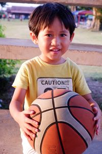 Portrait of smiling boy holding ball