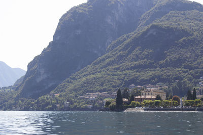 Lake amidst buildings against mountains