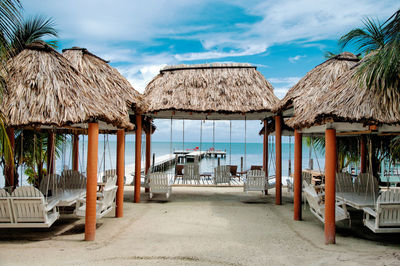 Built structure on beach against cloudy sky