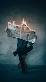 Digital composite image of man holding fire
