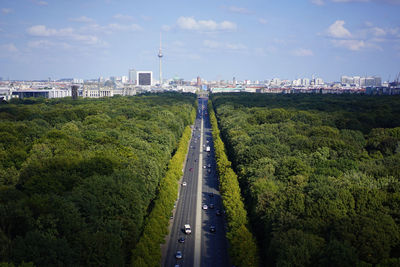 High angle view of road amidst trees against sky