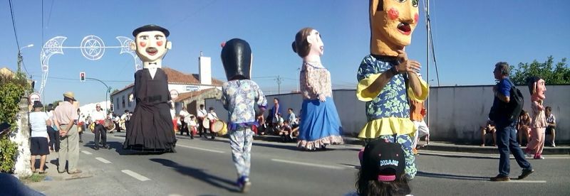 Full length of woman standing against blue sky