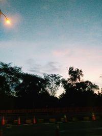 Silhouette trees against sky at dusk