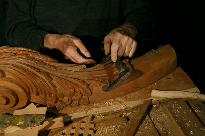 Midsection of man working at workshop