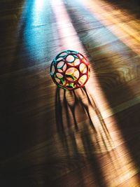 High angle view of multi colored balls on wooden table