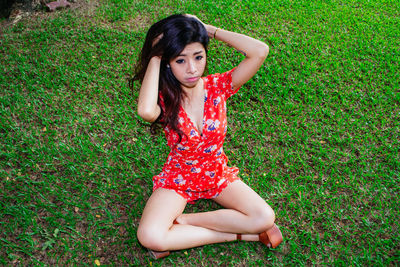 Portrait of young woman standing against plants