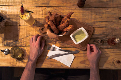 High angle view of man cutting board on table