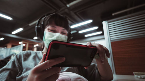 Low angle view of man using mobile phone