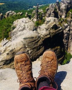 Low section of man standing on rock