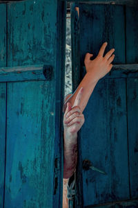 Cropped image of hand on closed door