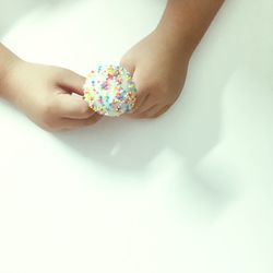 Close-up of hand holding flowers