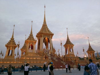 People at temple against sky