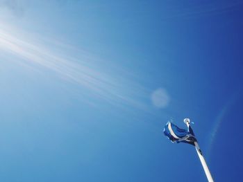 Low angle view of lizard against clear blue sky