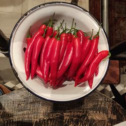 High angle view of red chili peppers in plate on table