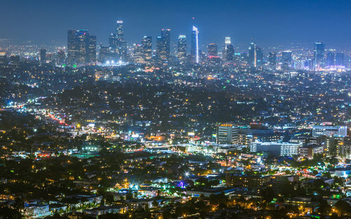 High angle view of illuminated buildings against sky at night