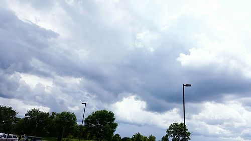 Low angle view of street light against cloudy sky