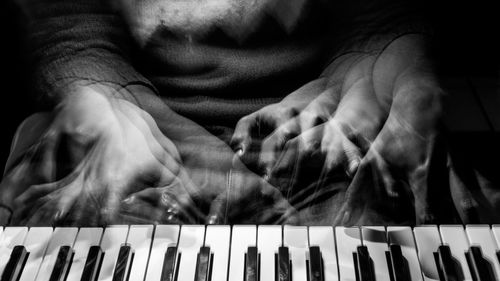 Close-up of man playing piano