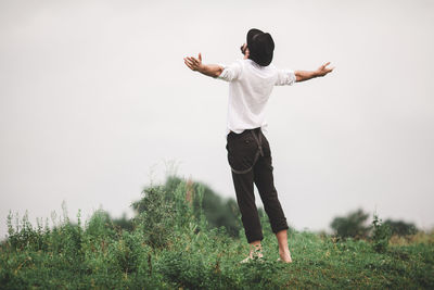 Full length of man standing on field against sky