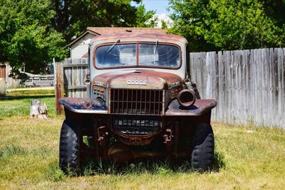 Abandoned vintage car on field