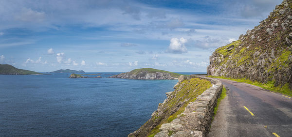 Road by sea against sky