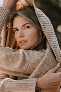 Portrait of woman removing sweater