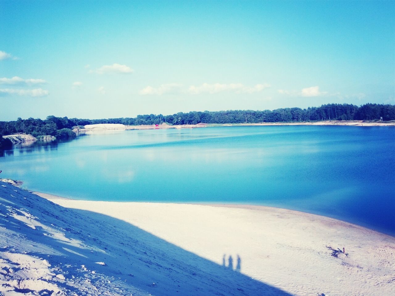 water, blue, tranquil scene, tranquility, scenics, beauty in nature, lake, reflection, sky, nature, idyllic, tree, mountain, calm, day, outdoors, non-urban scene, sea, no people, copy space