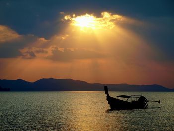 Boat in sea at sunset