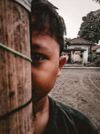 Close-up portrait of young man against sky