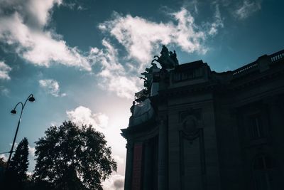 Low angle view of building against cloudy sky
