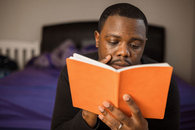 Portrait of man holding book