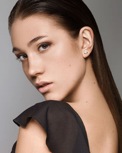 Close-up portrait of a beautiful young woman over white background