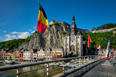 Panoramic view of flag on city against sky