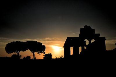 Silhouette buildings against sky during sunset