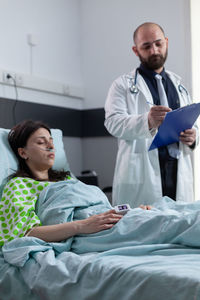 Portrait of doctor examining patient at clinic