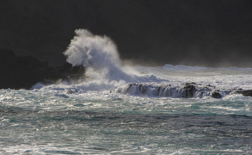 Water splashing in sea against sky