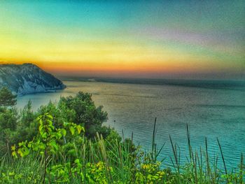 Scenic view of sea against sky at sunset